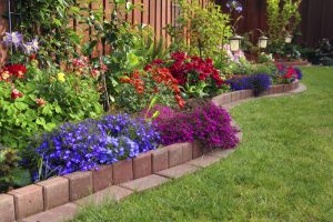 flower bed ideas here is a brick lined flowerbed against a fence in this yard. placing a  flower GZZQIQI