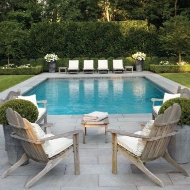 grass, grey stone paving, gorgeous pool furniture and i love the potted  flowers. DQUQVOO
