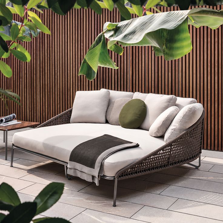 outdoor daybed aston is a family of individual pieces, including a sofa, daybed, armchairs, XRBKGLE