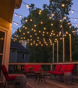patio lights hanging across a backyard deck ZQBGMXL