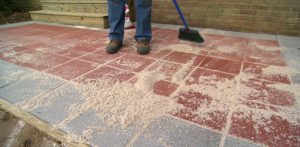 patio pavers sweeping sand between pavers. CBLCCGE