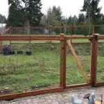 this garden fence in the outskirts of olympia has an access gate and a  double gate NVTJFDB