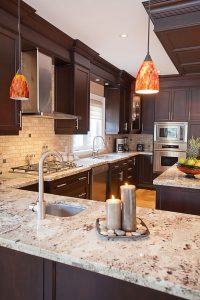 kitchen countertops giallo ornamental granite countertops dark wood cabinets stainless steel  appliances - sleek CBLNMPO