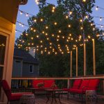 patio lights hanging across a backyard deck RBGXLWG