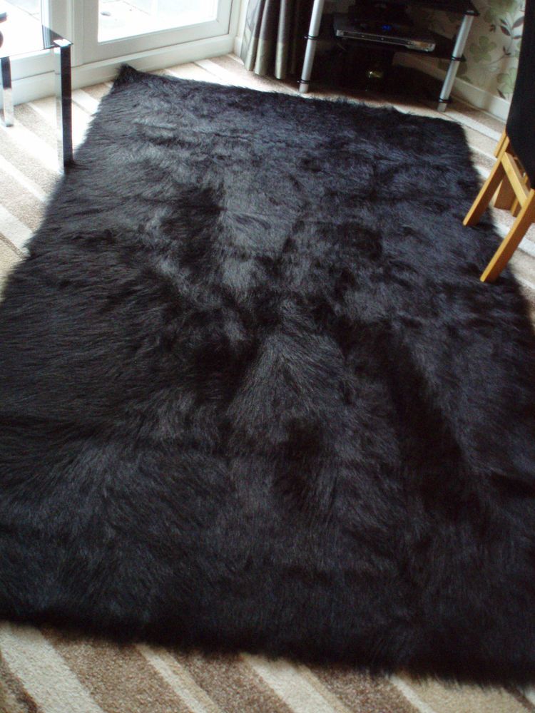 black rugs u0027special offeru0027 large black faux sheepskin shaggy fluffy rug 150 x 240cms OSAAMLM