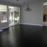 black wood flooring black hardwood floor to match stone fireplace, grey/yellow/ white decor PBRMQEB