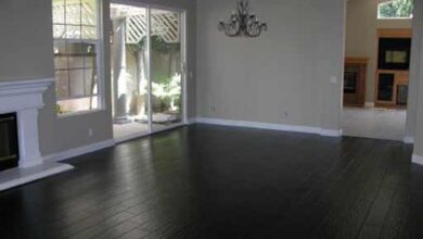 black wood flooring black hardwood floor to match stone fireplace, grey/yellow/ white decor PBRMQEB